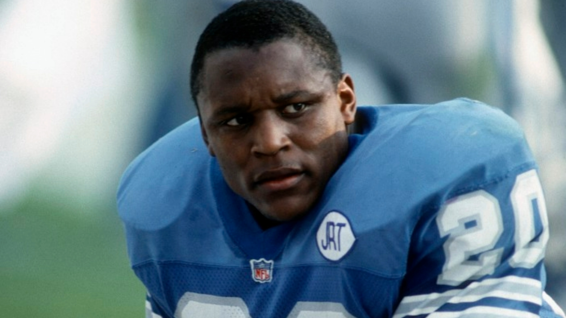 Barry Sanders running with the football