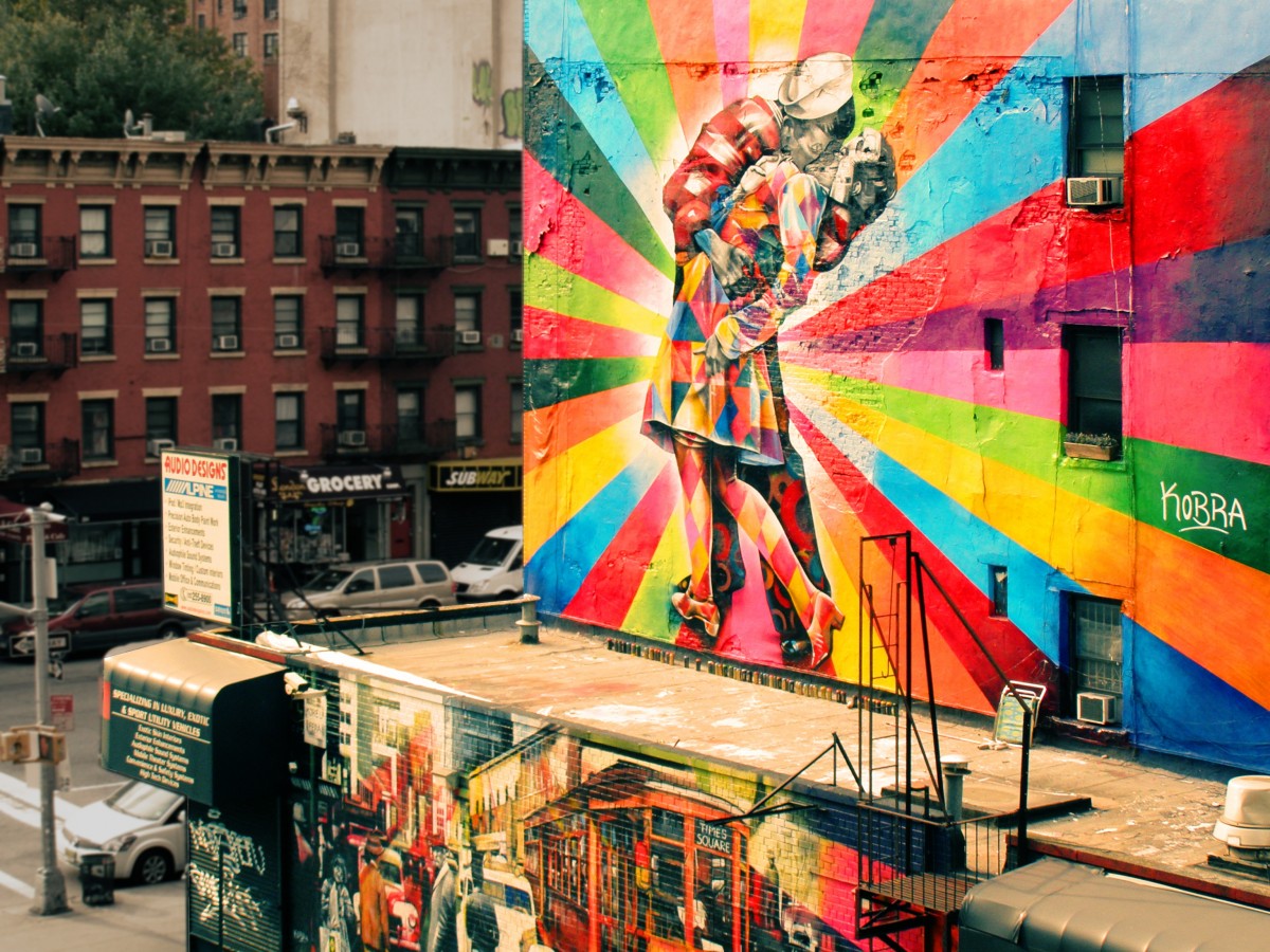 An old brick building with a large painted mural of local history